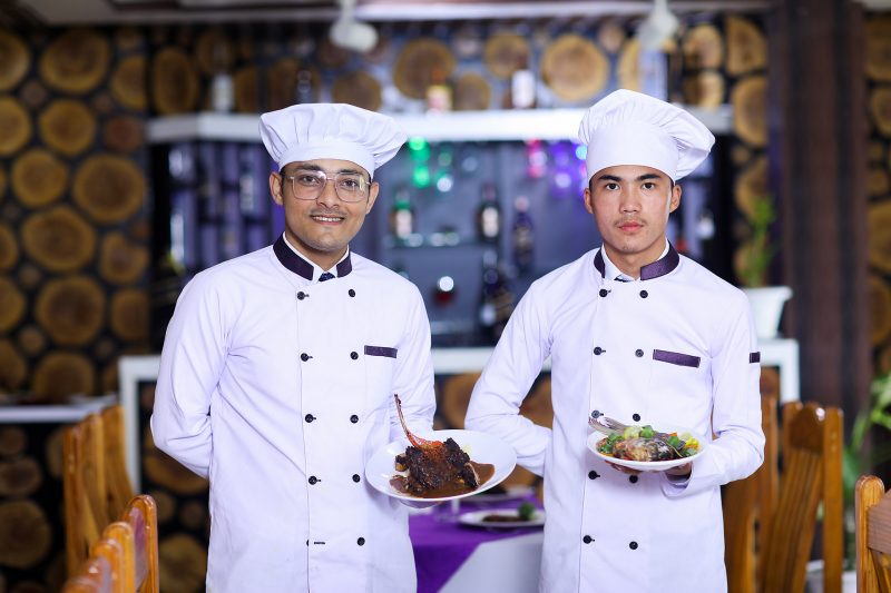 Image of two diploma in hotel management students with their practicle set.