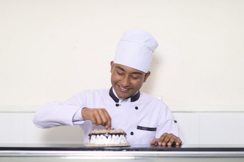 Aadarsha School Of Management Student Studying Diploma in Bakery And Pastries practising his craft.